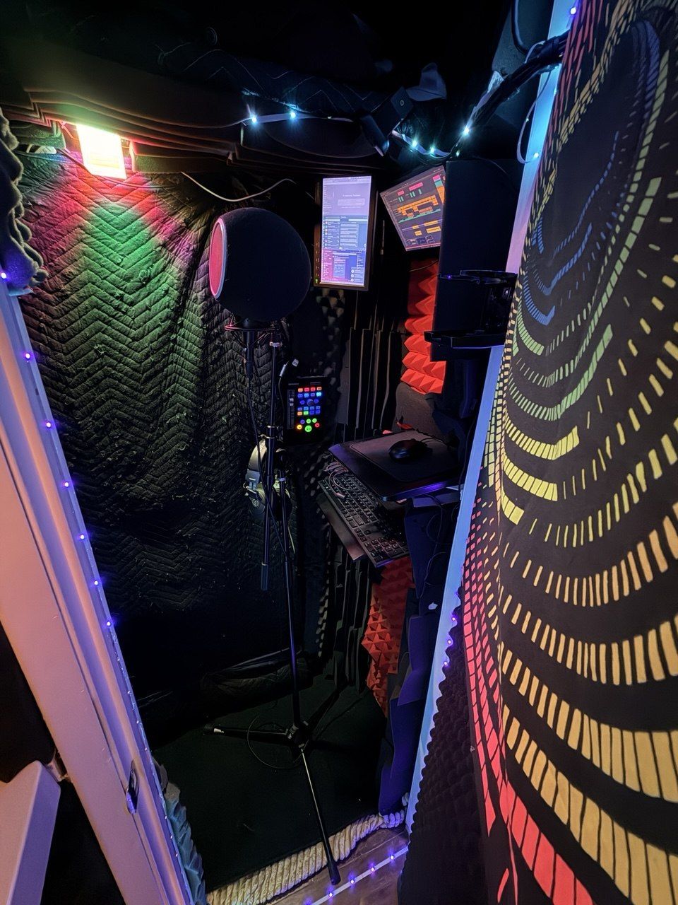 Vocal booth, acoustic blankets, foam, LED string lights, mic stand, psychedelic tapestry